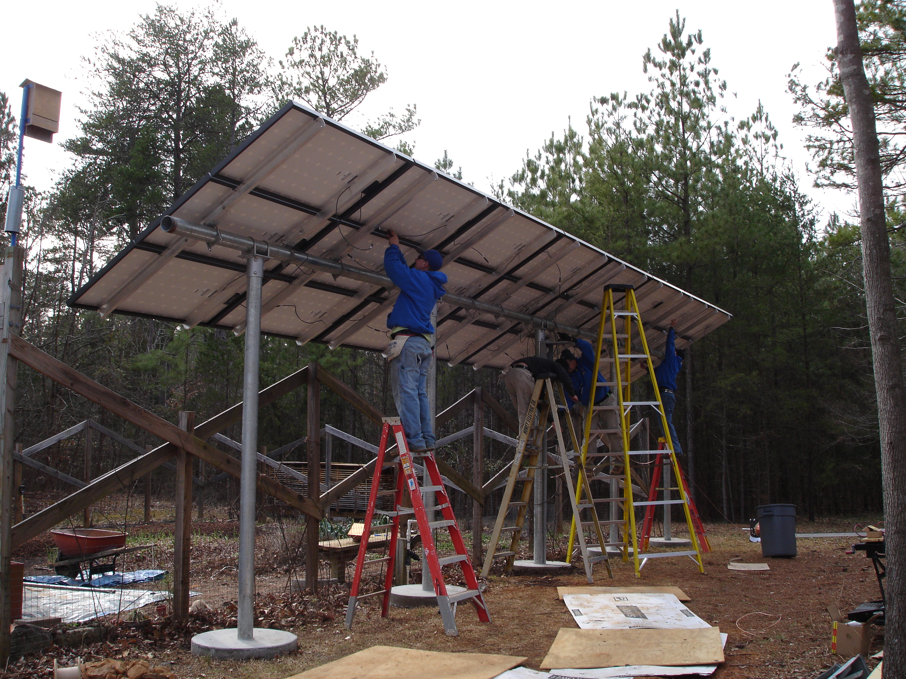 Installing photovoltaic panels onto the structure.